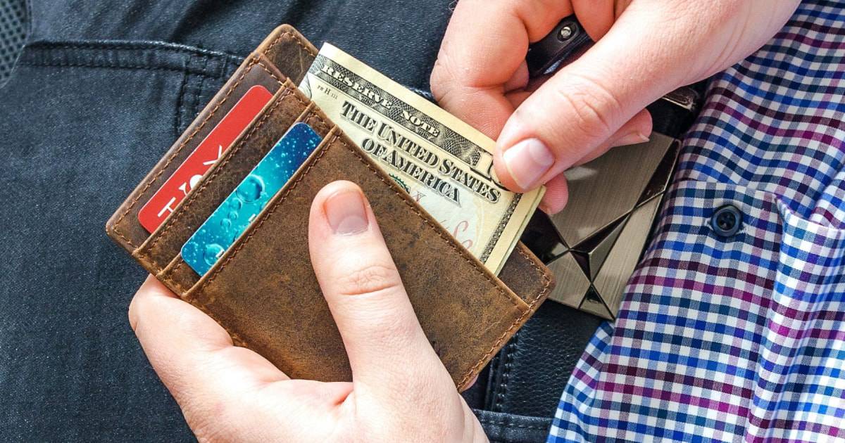 Man sitting down taking money out of wallet