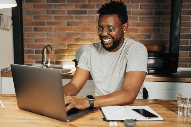 Man taking online vision test using laptop